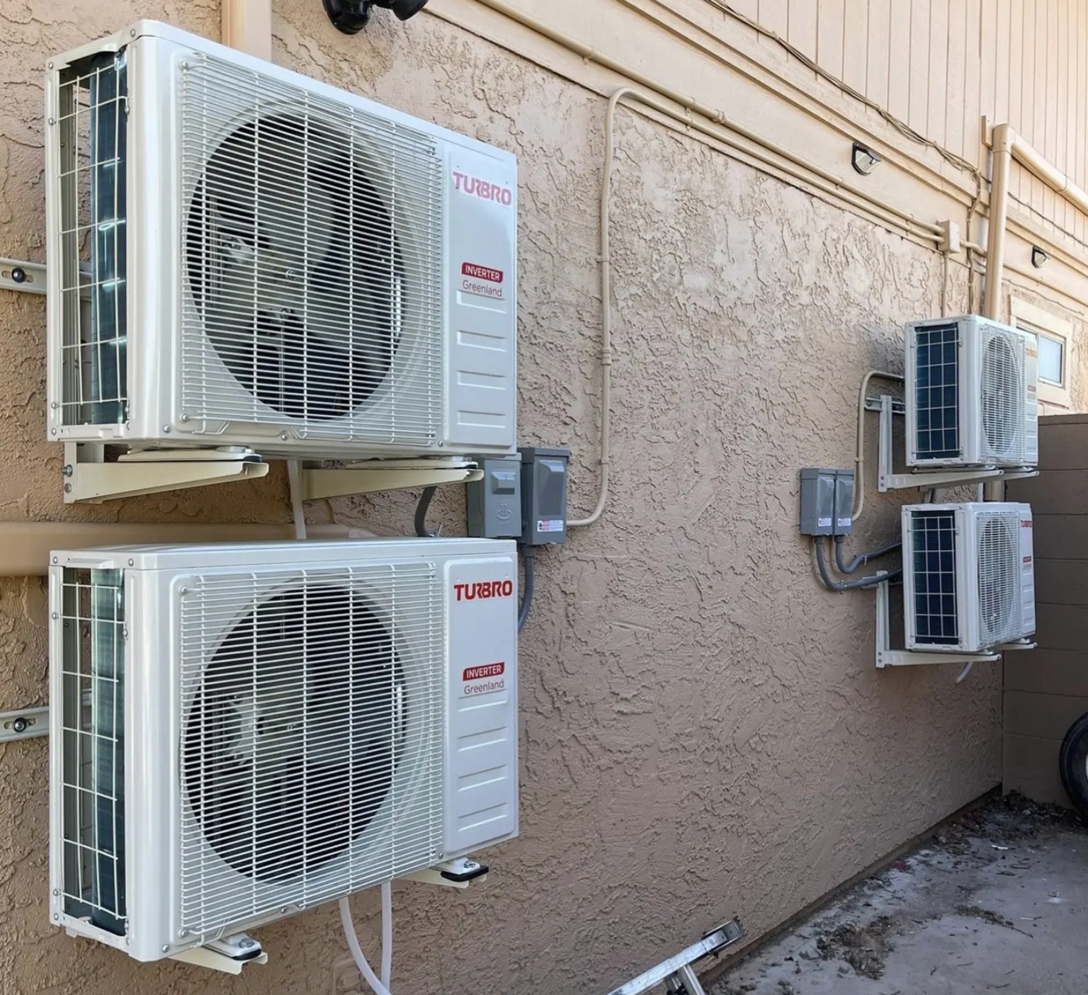 Four cleanly mounted outdoor mini-split condensers