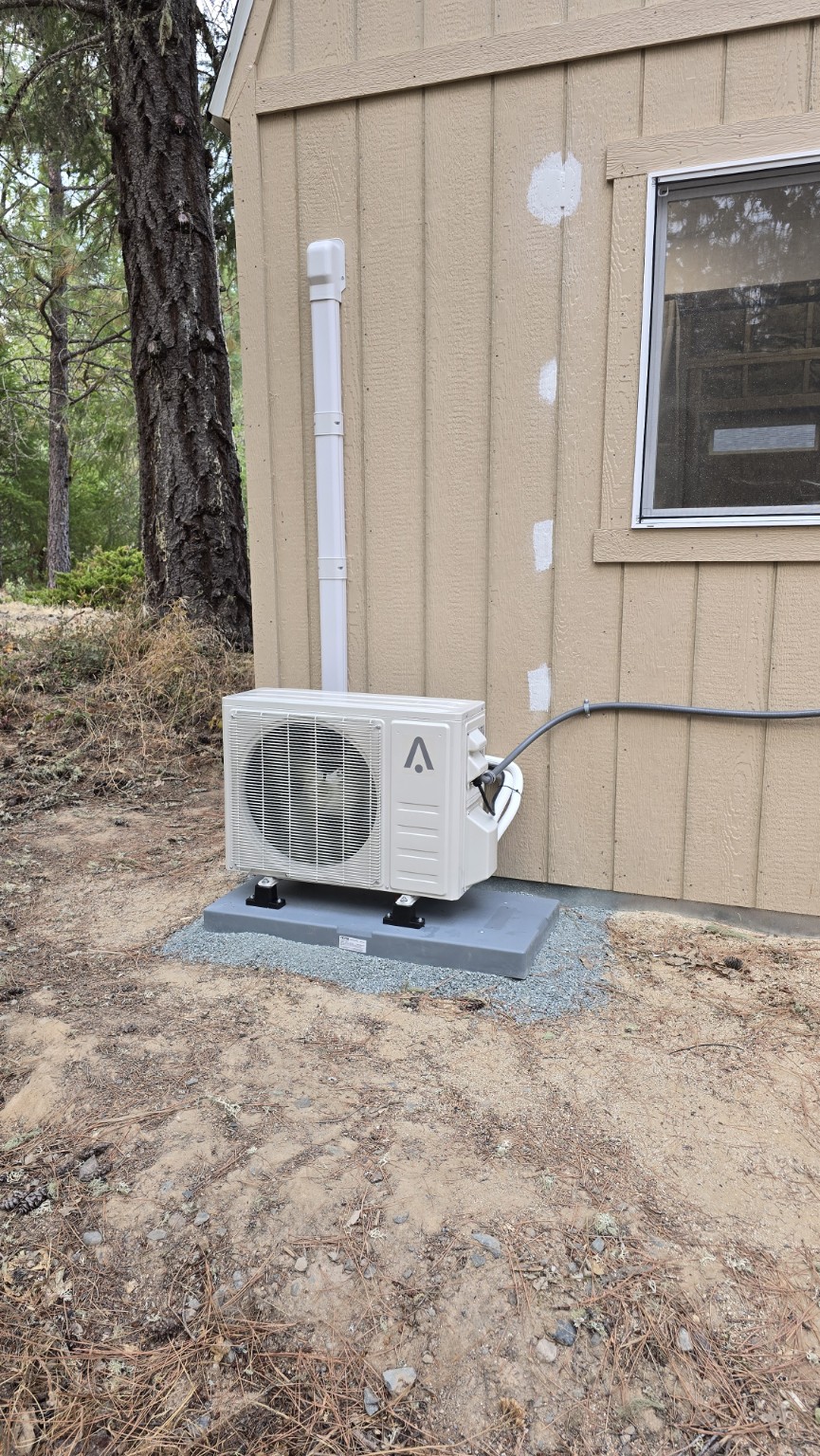 Finished outdoor mini-split condenser on a level equipment pad
